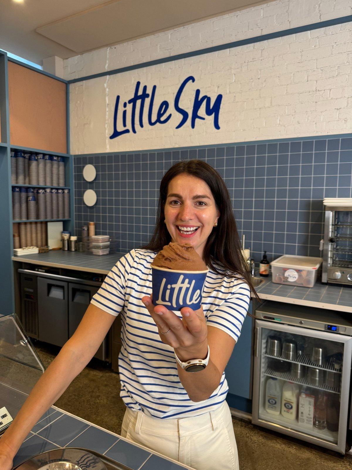 Snezana holding a cup of gelato behind the counter at Little Sky